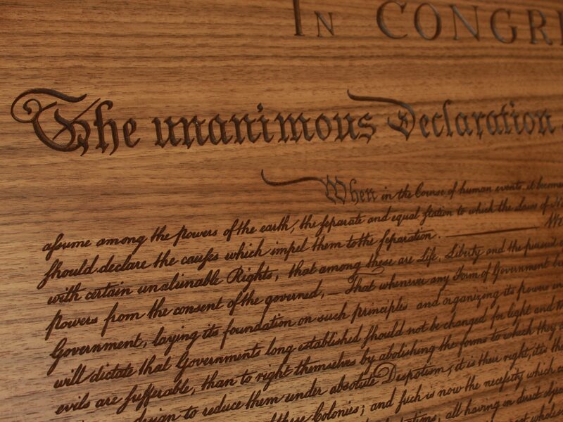 The opening lines of the Declaration carved in walnut
